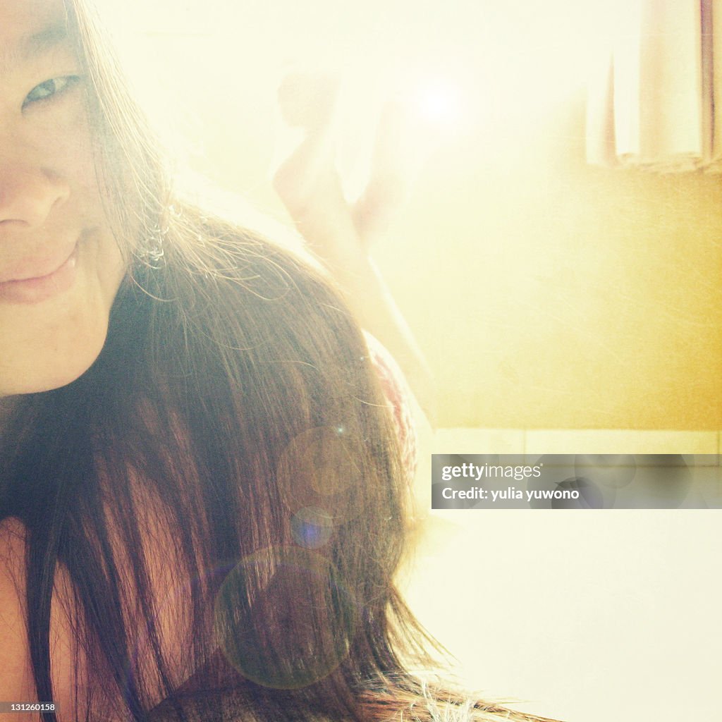 Side view of girl with sunlight falling on her