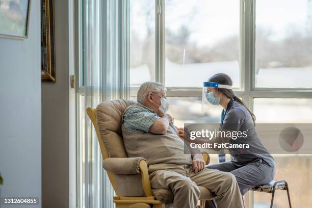 senior getting the covid-19 vaccine - aged care vaccine stock pictures, royalty-free photos & images