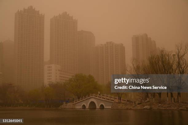 People visit a park as sandstorm hits the city on April 15, 2021 in Hohhot, Inner Mongolia Autonomous Region of China.
