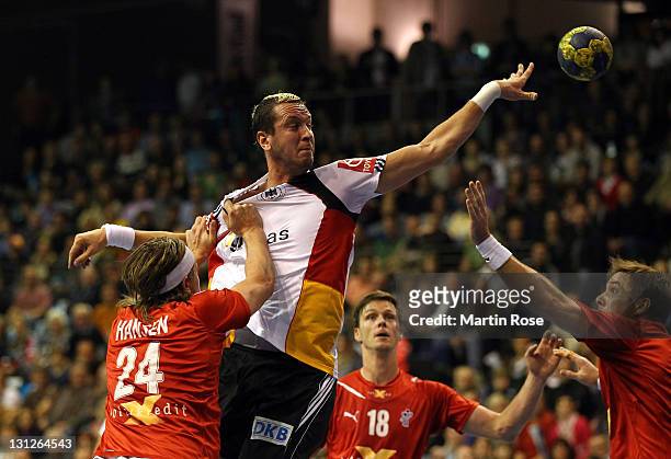 Pascal Hens of Germany and Mikkel Hansen of Denmark compete for the ball during the Mens'Handball Supercup match between Germany and Denmark at...