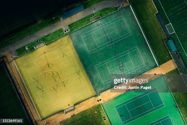 a drone view onto sports pitches illuminated at night - football pitch above stock pictures, royalty-free photos & images