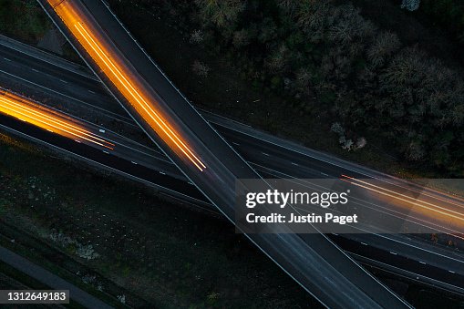 Drone view of cars moving in different directions at night Drone view of cars moving in different directions at night