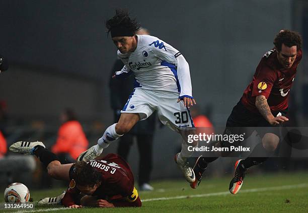 Christian Bolanos of Kobenhavn and Christian Schulz and Emanuel Pogatetz of Hannover battle for the ball during the UEFA Europa League Group B match...