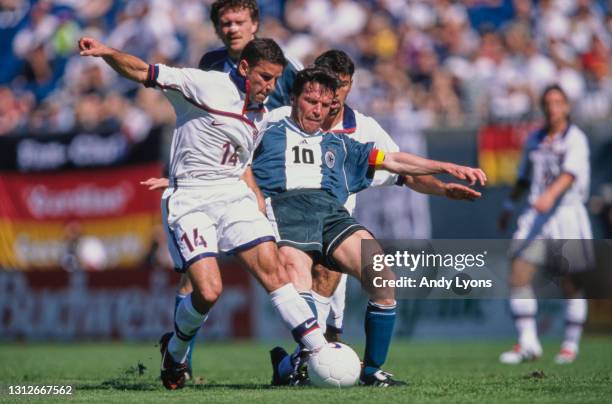 Chris Armas of Team USA goes into a tackle with Lothar Matthäus Germany during their match on 3rd February 1999 at the Alltel Stadium in...