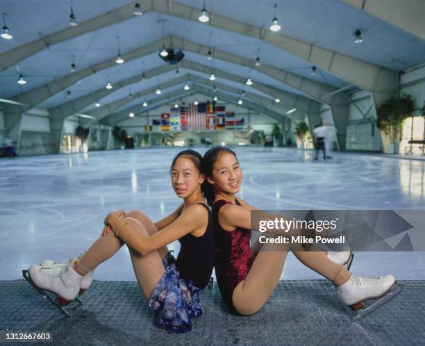 Sisters Karen and Michelle Kwan of the United States pose for a photograph following practice for their figure skating program routines on 23rd...