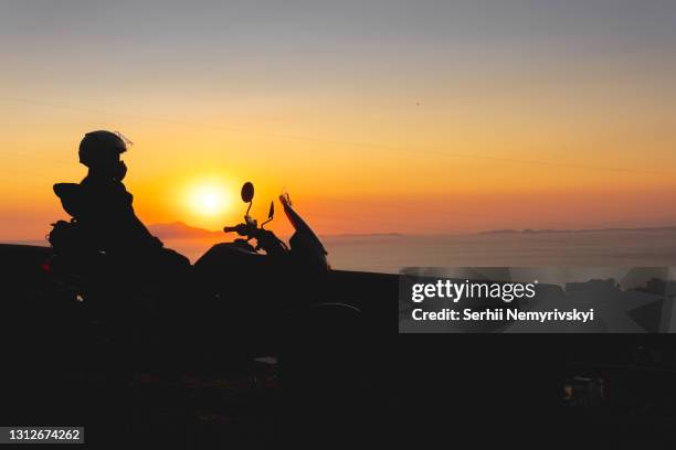 woman biker silhouette over sunset, female riding motorcycle, motorbike driver traveling, lady look on the beach, freedom lifestyle. travel and vacation. - italian beach fun stock pictures, royalty-free photos & images