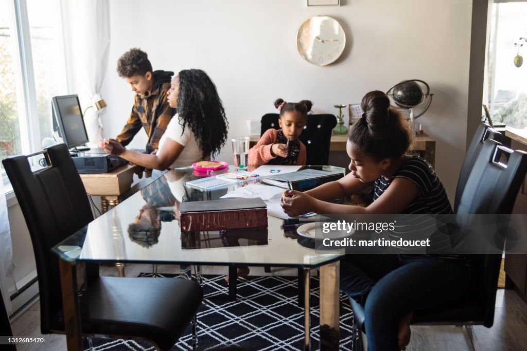Woman working from home in small space with children around.
