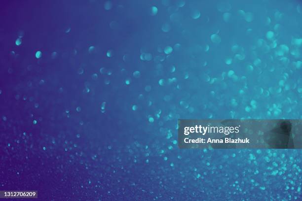 blue glowing glittering background. round sparkling bokeh. - blue confetti stockfoto's en -beelden