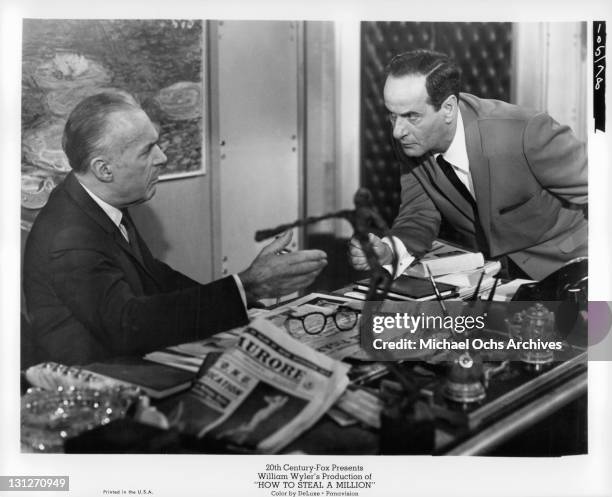 Charles Boyer warns Eli Wallach of the impending dangers of forgery in a scene from the film 'How To Steal A Million', 1966.