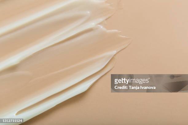 liquid gel cream texture on beige background. - lap body area stock-fotos und bilder