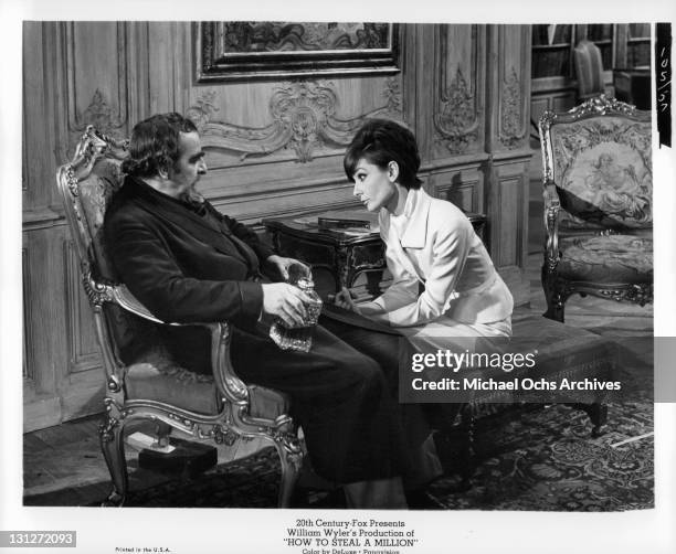 Audrey Hepburn tries to comfort Hugh Griffith in a scene from the film 'How To Steal A Million', 1966.