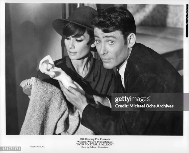 Audrey Hepburn and Peter O'Toole take the final steps during a million dollar Paris art museum theft in a scene from the film 'How To Steal A...