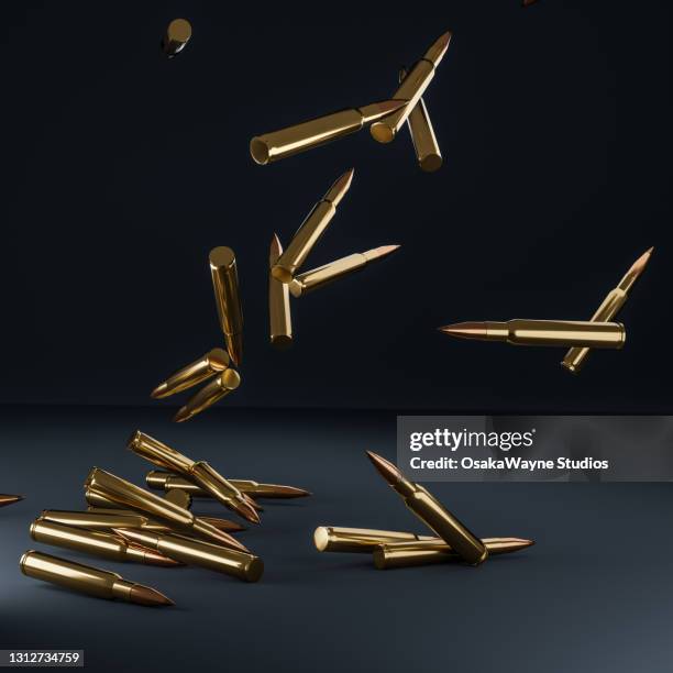 shiny metal rifle bullets falling down over dark background. - kogel stockfoto's en -beelden