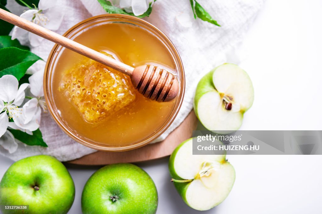 Green apples and honey bowl