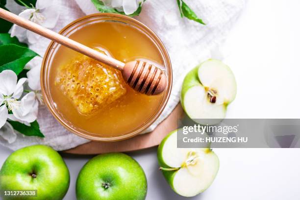green apples and honey bowl - rosh hashanah stock pictures, royalty-free photos & images