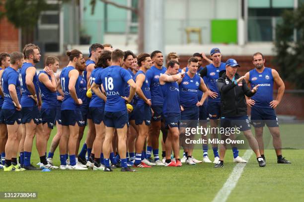 David Noble, senior coach of the Kangaroos is seen talking to his players during a North Melbourne Kangaroos AFL training session at Arden Street...