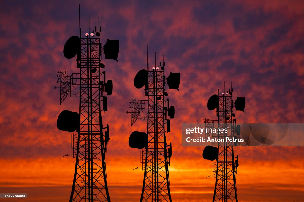 Communication tower against the background of the sunset sky. Communication concept
