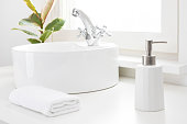 Bathroom hand washing concept with sink, towel and soap dispenser