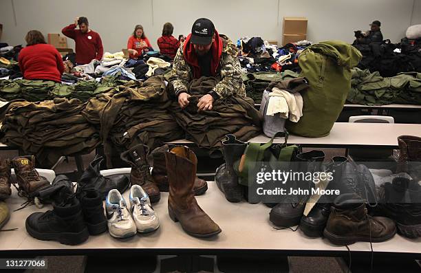 Homeless U.S. Navy veteran Wayne Hamilton looks for his size while collecting free clothing at a "Stand Down" event hosted by the Department of...