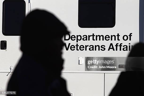 Homeless U.S. Military veterans stand in line for free services at a "Stand Down" event hosted by the Department of Veterans Affairs on November 3,...