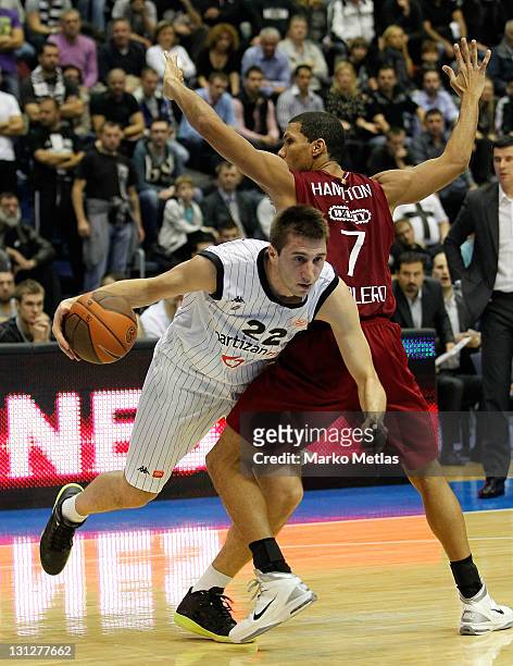 Marko Cakarevic of Partizan MTS Belgrade competes with Justin Hamilton, #7 of Belgacom Spirou Basket during the 2011-2012 Turkish Airlines Euroleague...