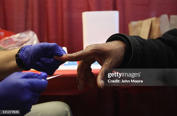 Homeless U.S. Military veteran has blood drawn for a free HIV test at a "Stand Down" event hosted by the Department of Veterans Affairs on November...