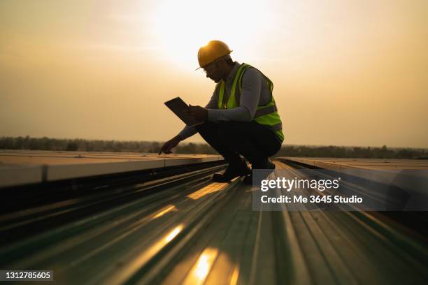 solar power plant engineers and examining photovoltaic panels.  electrical and instrument technician use laptop to maintenance electric solution. - solar energy bildbanksfoton och bilder