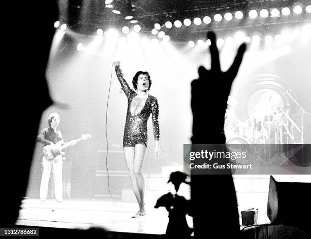 John Deacon and Freddie Mercury, Roger Taylor of Queen perform on stage at Wembley Arena during their 'News Of The World' tour in London, England, on...