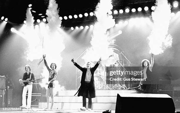 John Deacon, Freddie Mercury, Roger Taylor and Brian May of Queen perform on stage at Wembley Arena during their 'News Of The World' tour in London,...