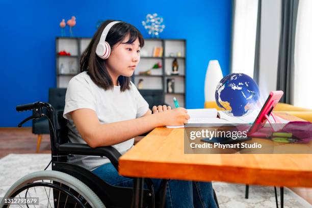 teenage girl  having online school class at home - kid headphones stock pictures, royalty-free photos & images