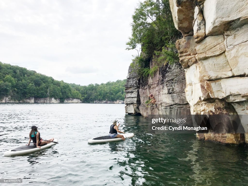 Women Watching a Woman Jump off a Rockface into Summersville Lake