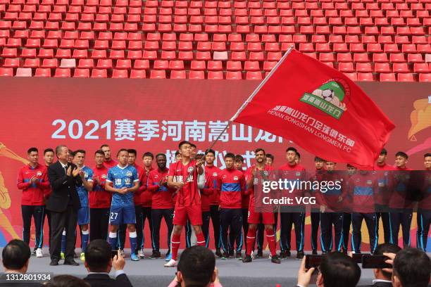 Players of Henan Songshan Longmen Football Club attend a farewell ceremony before leaving for 2021 Chinese Super League at Hanghai Stadium on April...