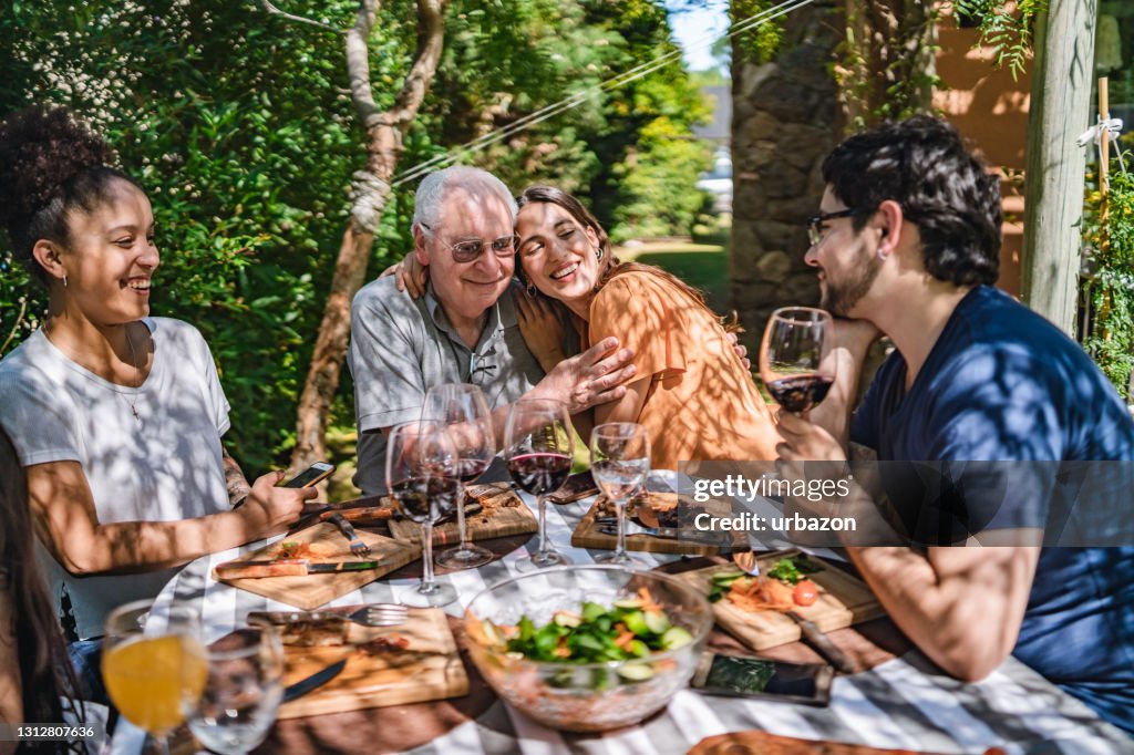 Father and daughter embracing at family lunch