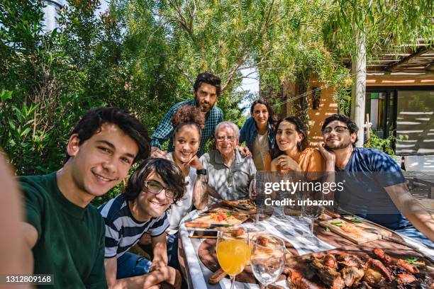 argentine family making selfie at traditional asado midday meal - argentina traditional food stock pictures, royalty-free photos & images