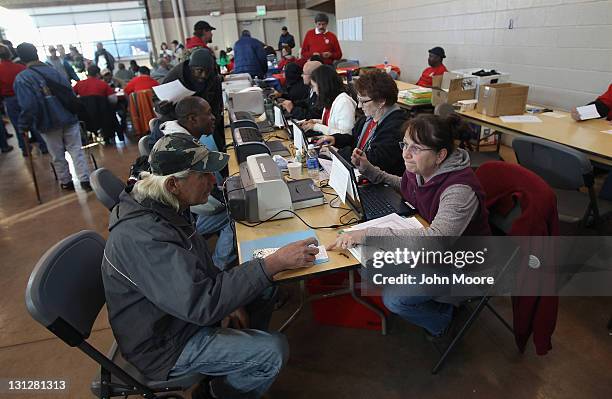 Homeless U.S. Military veterans receive information on free government services at a "Stand Down" event hosted by the Department of Veterans Affairs...