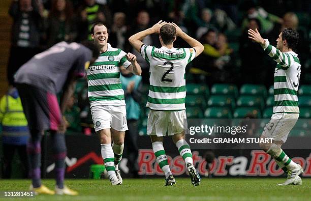 Celtic's Anthony Stokes celebrates with his teammates Adam Matthews and Beram Kayal after scoring his team's second goal against Rennes during their...