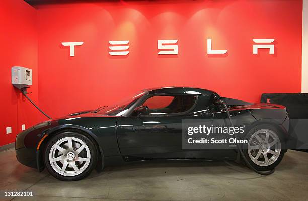 Tesla Roadster Sport sits in a dealership showroom on November 3, 2011 in Chicago, Illinois. Tesla Motors Inc. Stock rose more than 13 percent today...