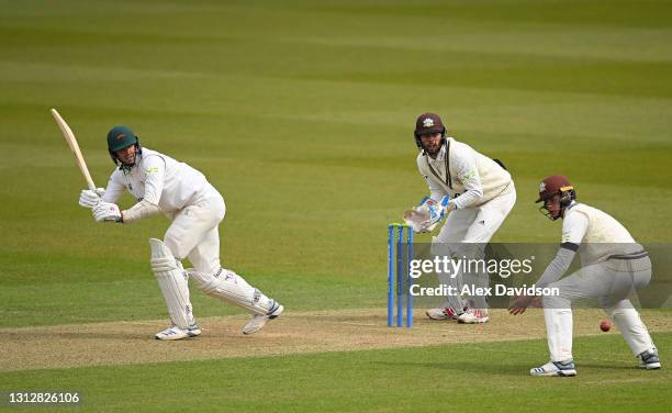 Chris Wright of Leicestershire hits runs watched on by Ben Foakes of Surrey during Day Two of the LV= Insurance County Championship match between...