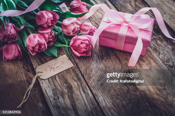 mother's day gift on rustic wooden table - brown box stock pictures, royalty-free photos & images