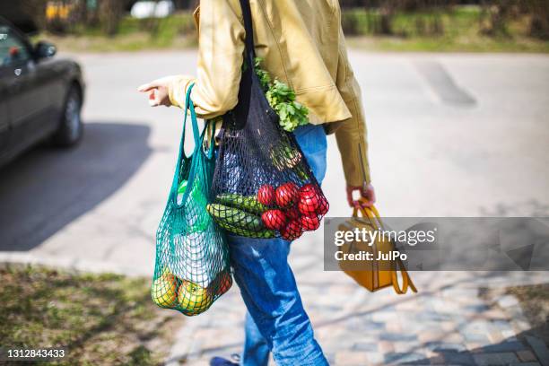 young woman with cotton bags buying vegetables and fruits at farmer market - plastic free stock pictures, royalty-free photos & images