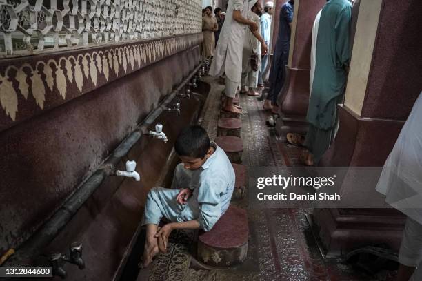 Muslims perform ablutions before joining Friday prayers on April 16, 2021 in Peshawar, Pakistan. Pakistan began observing the Islamic holy month of...