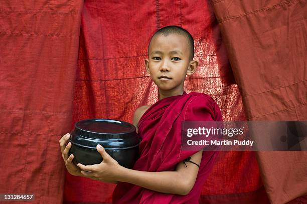 buddhist monk holding bowl for offerings - boeddhisme stockfoto's en -beelden