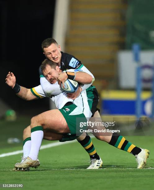 Fraser Dingwall of Northampton Saints tackles London Irish prop Allan Dell during the Gallagher Premiership Rugby match between Northampton Saints...