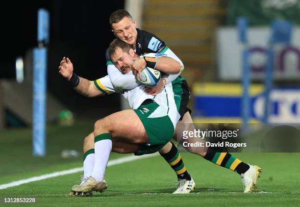 Fraser Dingwall of Northampton Saints tackles London Irish prop Allan Dell during the Gallagher Premiership Rugby match between Northampton Saints...