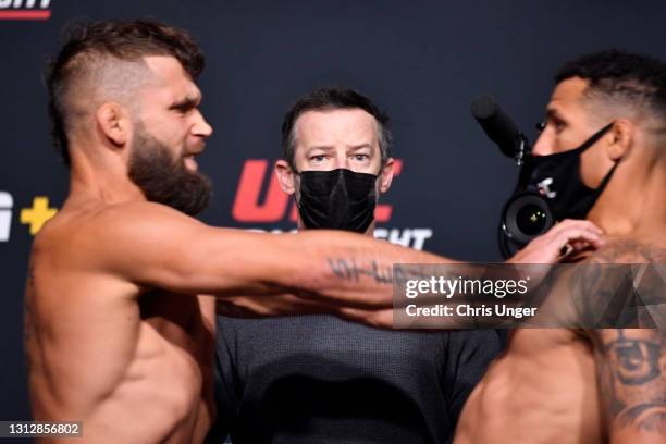 Opponents Jeremy Stephens and Drakkar Klose face off while UFC matchmaker Sean Shelby looks on during the UFC weigh-in at UFC APEX on April 16, 2021...