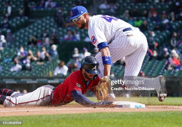 Kris Bryant of the Chicago Cubs tags out Dansby Swanson of the Atlanta Braves at third base during the fifth inning of a game at Wrigley Field on...