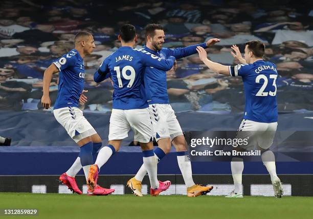 Gylfi Sigurdsson of Everton celebrates with teammates Seamus Coleman and James Rodriguez after scoring their team's second goal during the Premier...