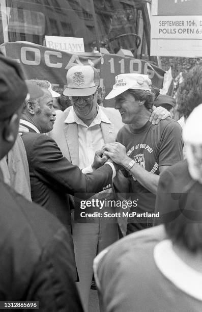 New York City Clerk David Dinkins shakes hands with a union member from the Communications Workers of America , while campaigning for Manhattan...
