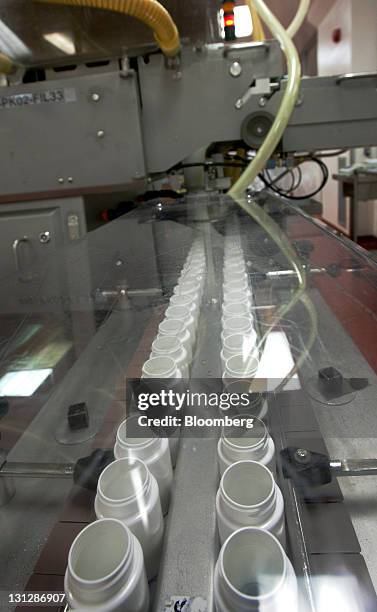 Empty pill bottles move along a distribution line before being filled at the Apotex Inc. Plant in Toronto, Ontario, Canada, on Wednesday, Nov. 3,...