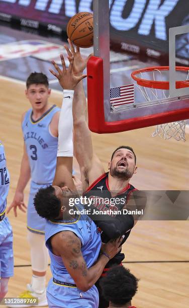 Nikola Vucevic of the Chicago Bulls shoots against Xavier Tillman of the Memphis Grizzlies at the United Center on April 16, 2021 in Chicago,...